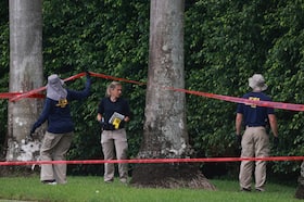 Law enforcement personnel investigate the area around Trump International Golf Club after an apparent assassination attempt on former president Donald Trump on Monday in West Palm Beach, Fla.