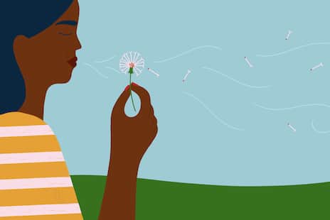 An illustration of someone blowing on a dandelion.