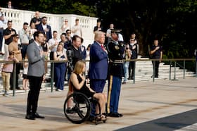 Republican presidential nominee Donald Trump joins Marlon Bateman, left, former Marine Cpl. Kelsee Lainhart and Marine Sgt. Tyler Vargas-Andrews on Aug. 26 at the Tomb of the Unknowns at Arlington National Cemetery for a wreath-laying ceremony to honor those who died at the Abbey Gate bombing in Afghanistan.